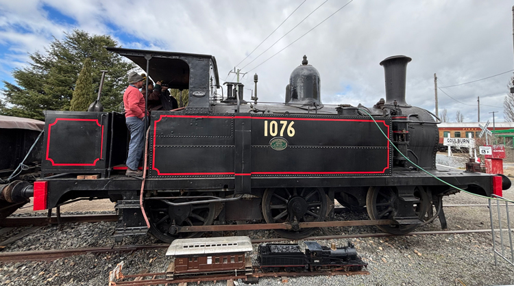 A person standing on the side of a train
AI-generated content may be incorrect.