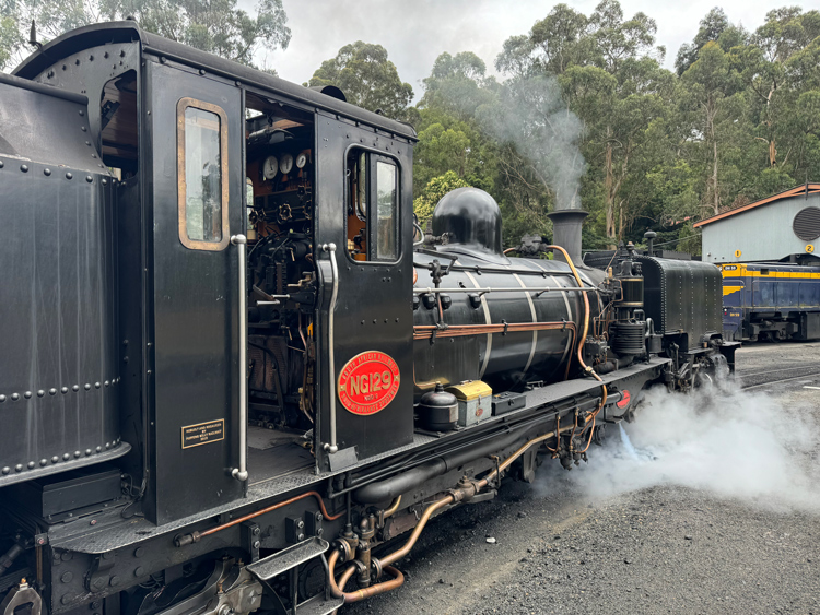 A black train with smoke coming out of it

Description automatically generated