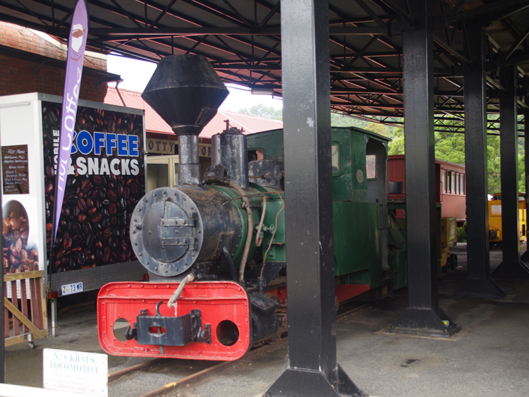 A green train in a museum

Description automatically generated with low confidence