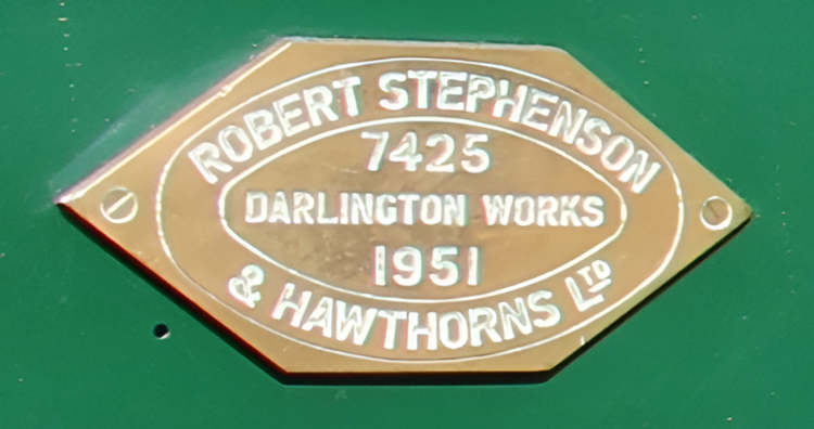 A gold plaque with white text on a green surface

AI-generated content may be incorrect.