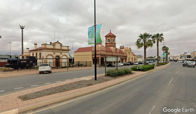 A street with cars and buildings along it

Description automatically generated with medium confidence